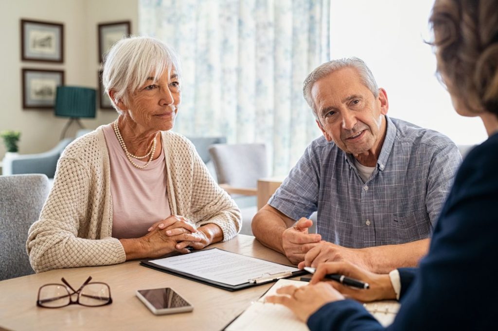 An older couple meeting with an advisor over paperwork